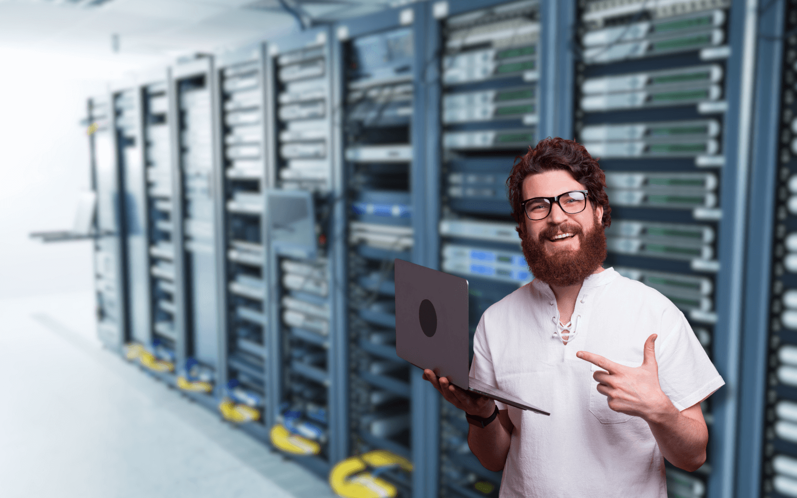 A person in a server room holds a laptop and points, symbolizing the average cost of IT services. The image reflects efficient IT support talking about average cost of managed it services for SMBs